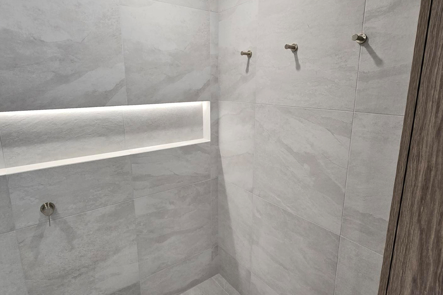 New shower interior with tiled niche and LED lighting