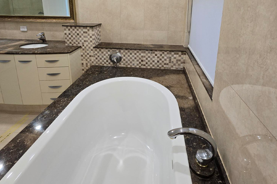 Old bathtub, vanity and window before renovation - Hope Island Gold Coast